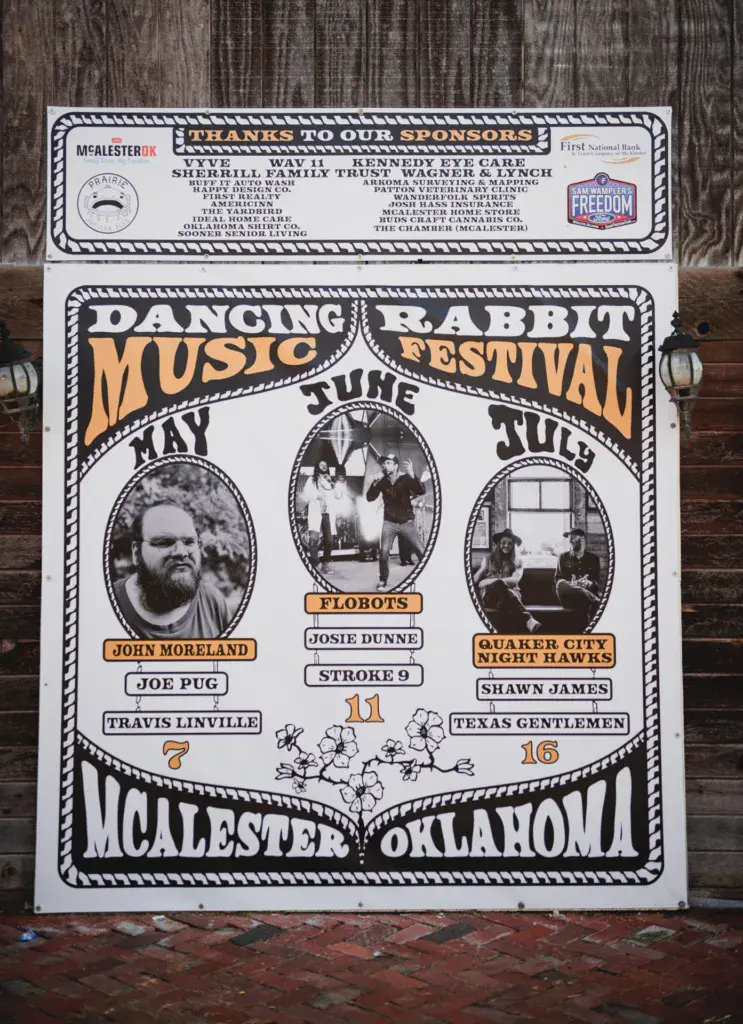 A vintage-style poster for the Dancing Rabbit Music Festival in McAlester, Oklahoma, displaying performer names and event dates.