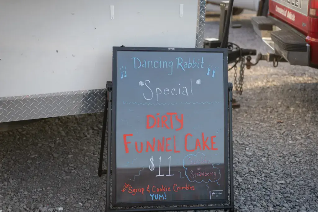 A chalkboard menu at Dancing Rabbit Music Festival advertising a Dirty Funnel Cake special for $11.